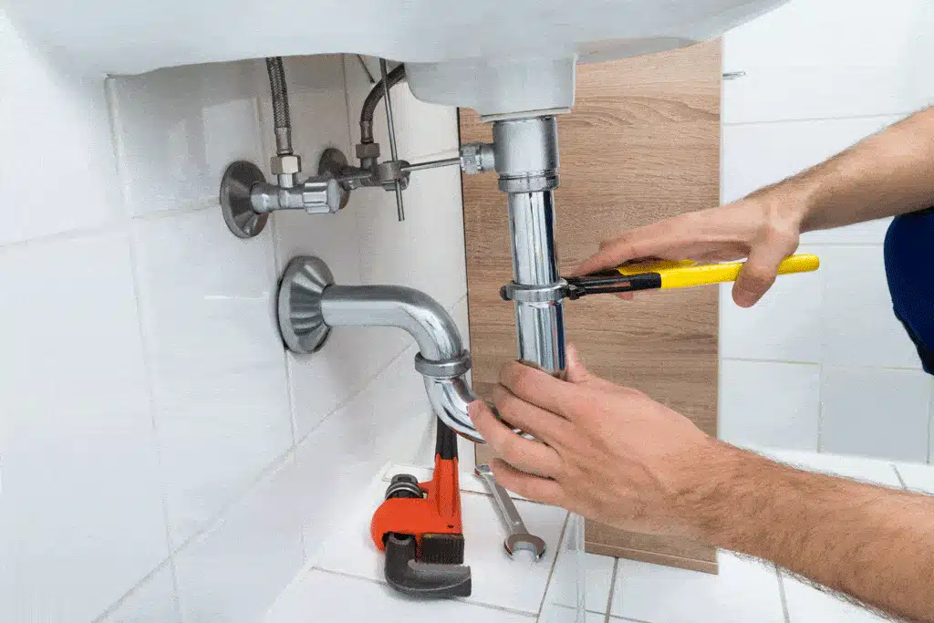 plumber-using-wrench-to-fix-sink-pipe-water-softner-installation-plano-tx-frisco-tx-dallas-tx