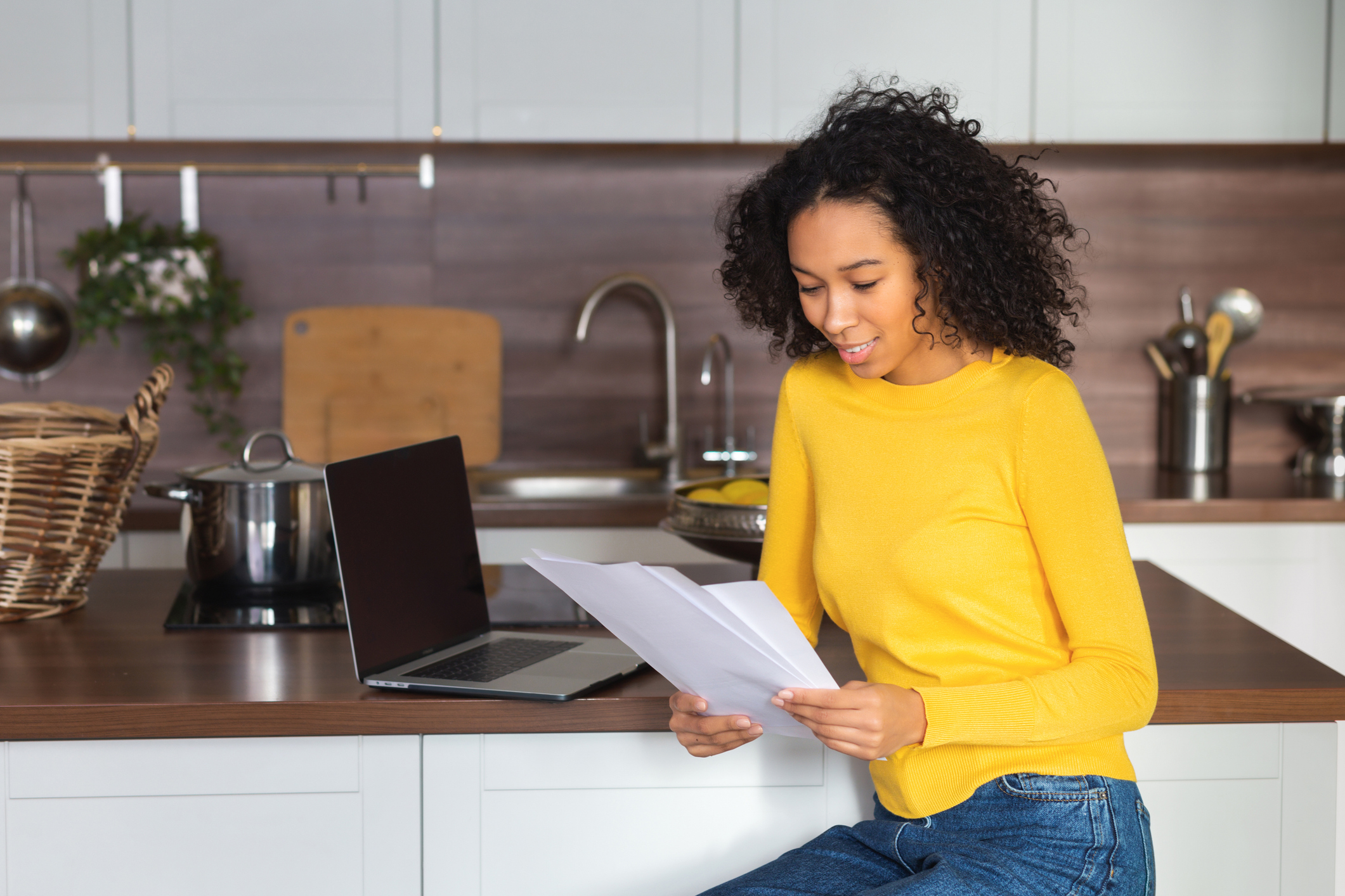 An African American woman enjoys lower energy bills thanks to an energy-efficient water heater.
