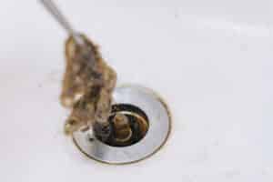 The hair is taken out of the drain in the sink, Residential Plumbing Overflows.