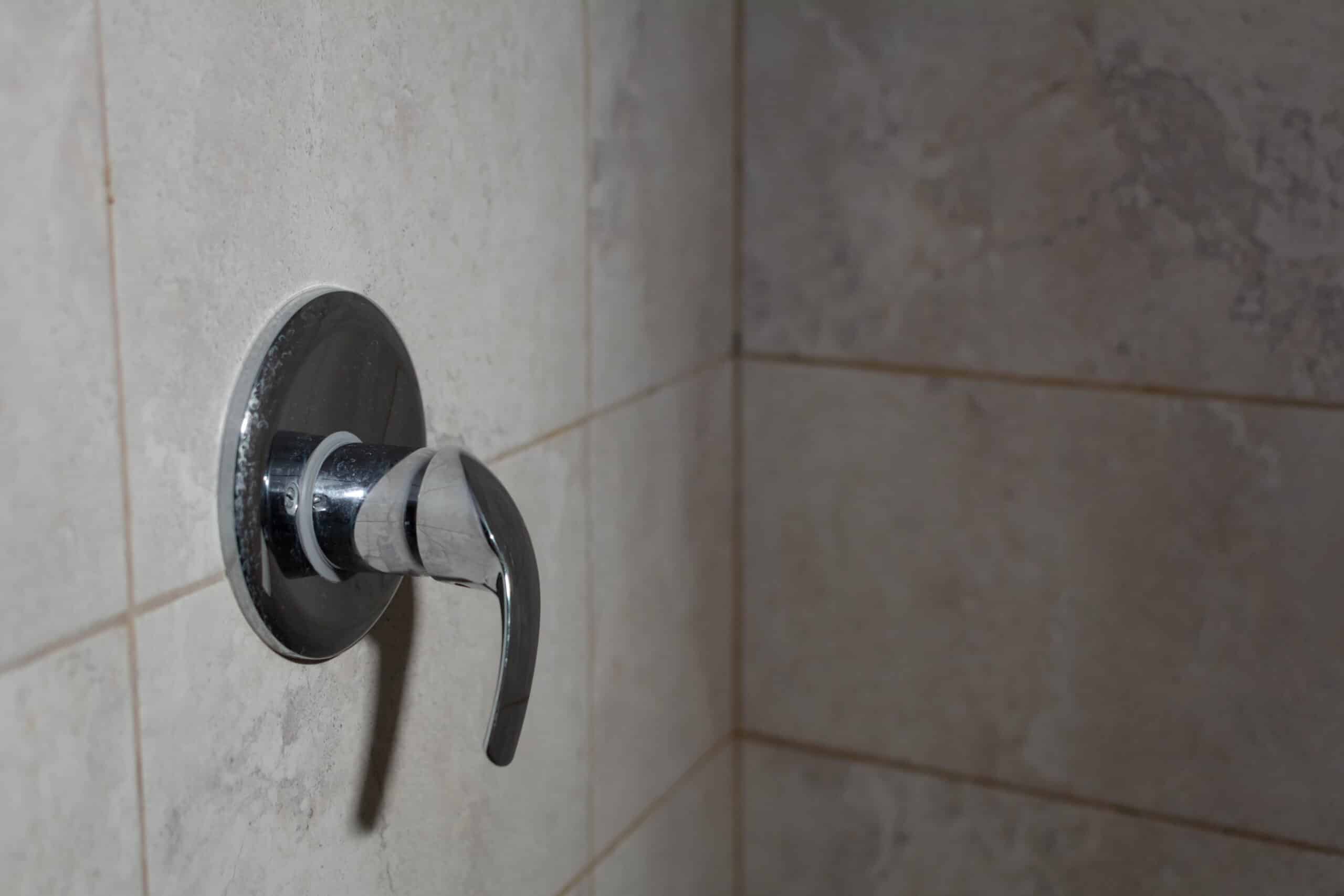 Limescale deposits on the water control handle in the shower, Mixing Valve Repair.