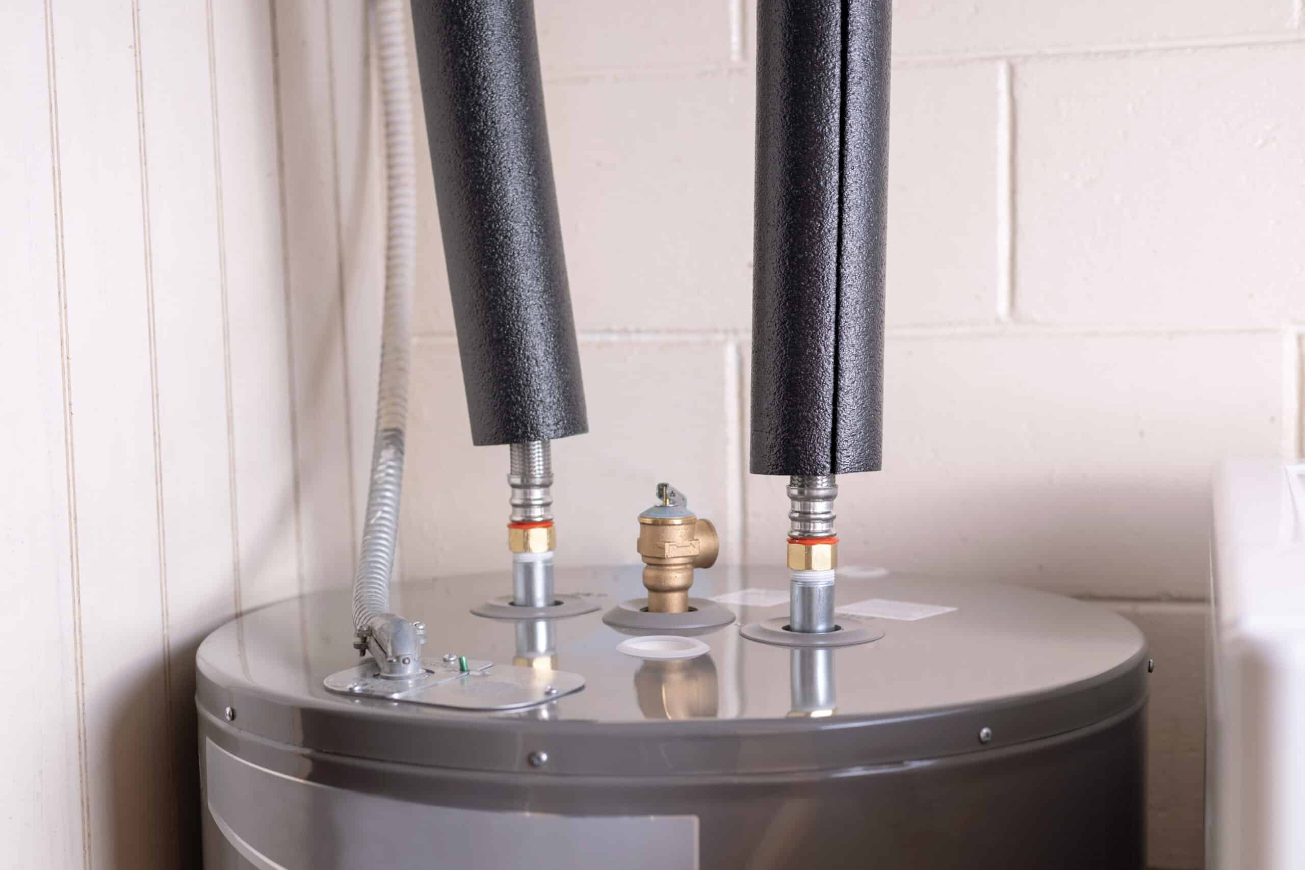 Water heater pipes covered with foam insulation, Water Heater Needs Replacing.