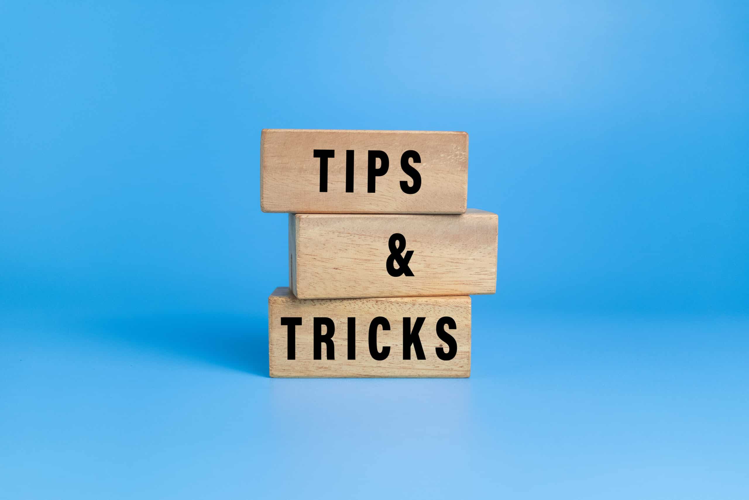 Tips and tricks words on wooden blocks isolated on blue background, Storm drain clearing.