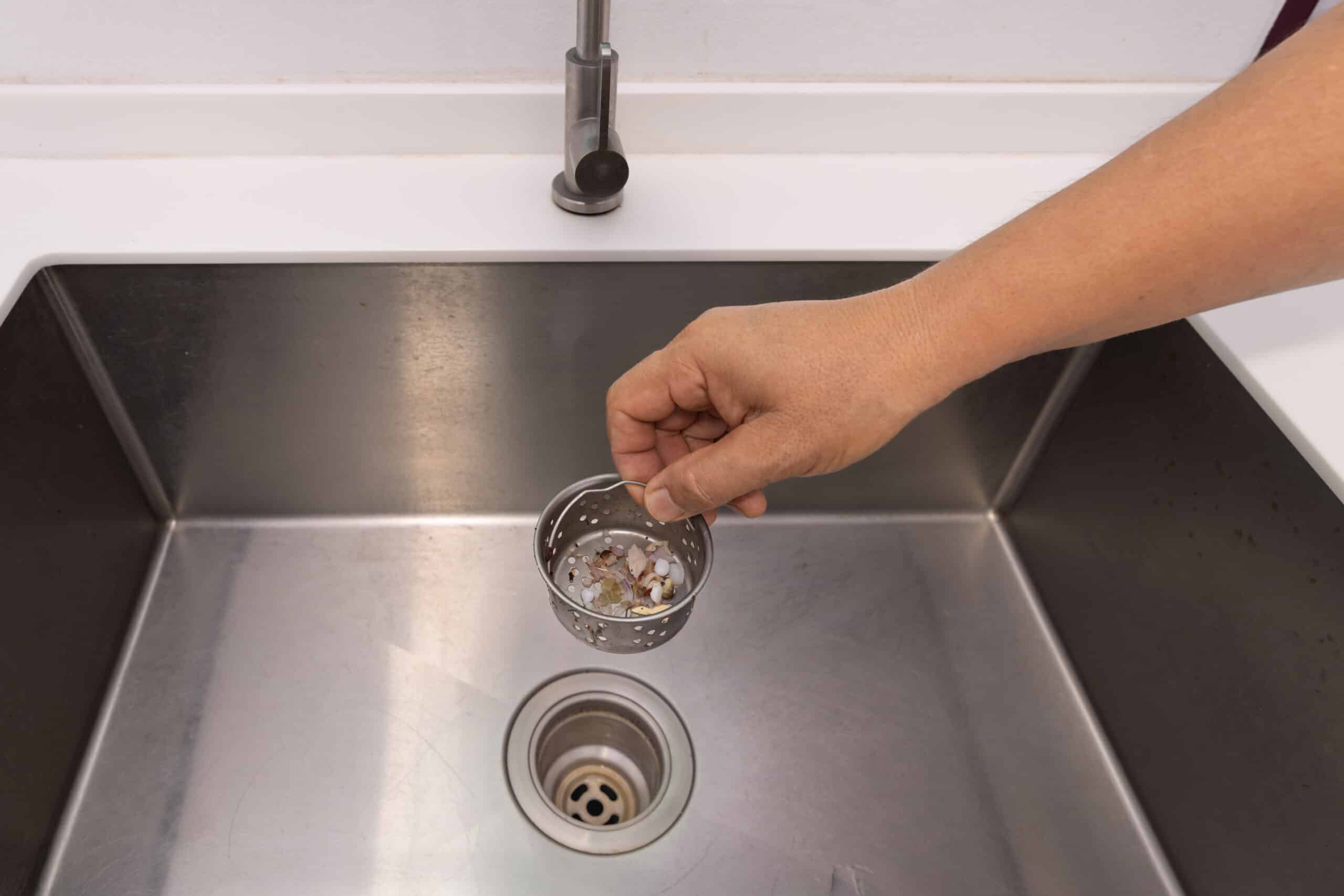 Food scraps in the basket strainer of sink, Drain Cleaning.