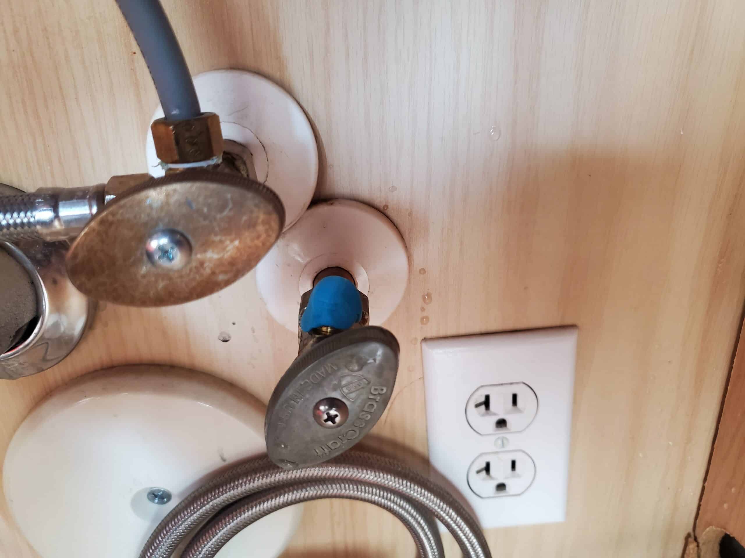 Hot and cold home water shutoff valves under kitchen sink.