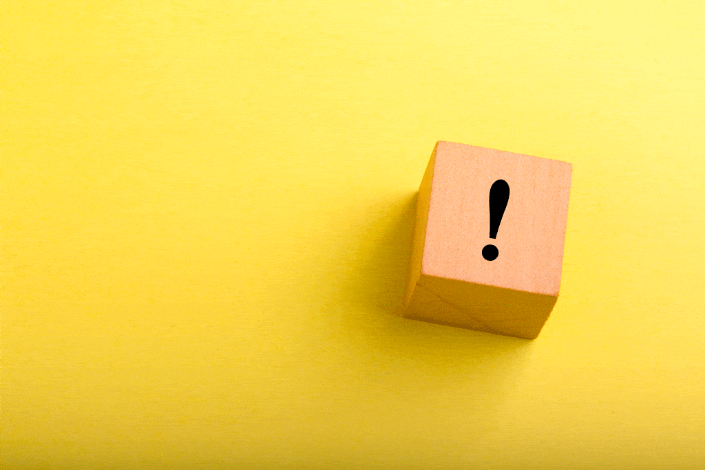 exlamation mark on wooden block on yellow background tankless water heater repair dallas tx frisco tx