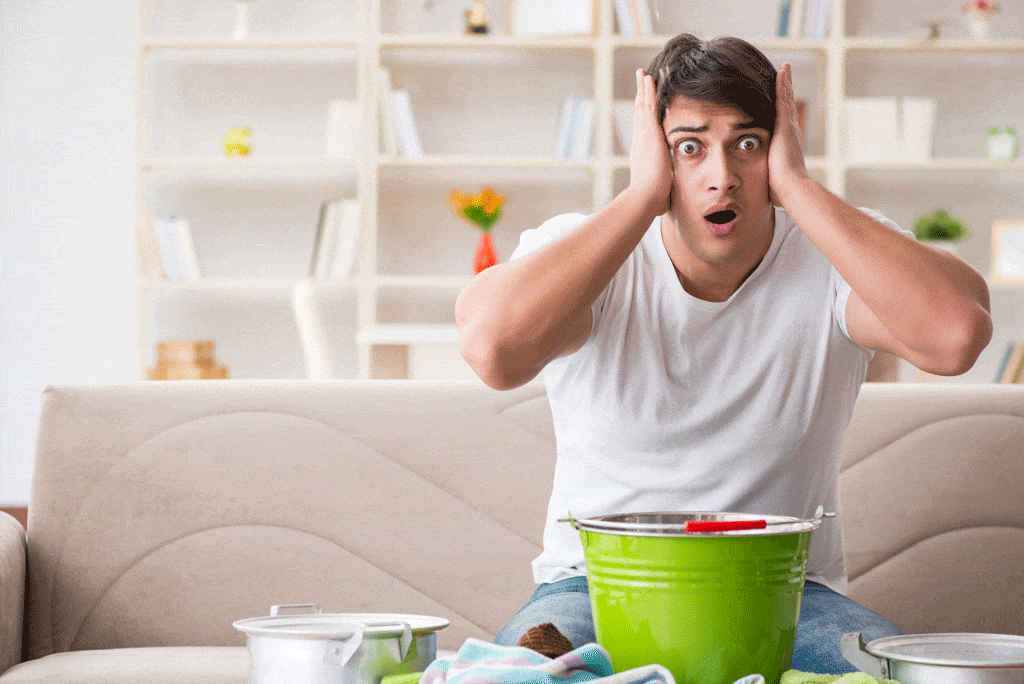 man at home with water leak and frustrated face water heater installation dallas tx ft worth tx